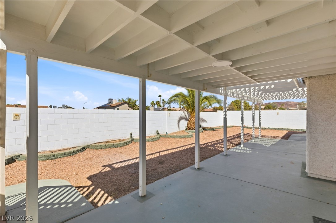 904 Shadowfax Road Henderson, NV 89015 - Photo 22 of 31 An expansive covered patio overlooks the low-maintenance desert yard enclosed by block wall fencing.