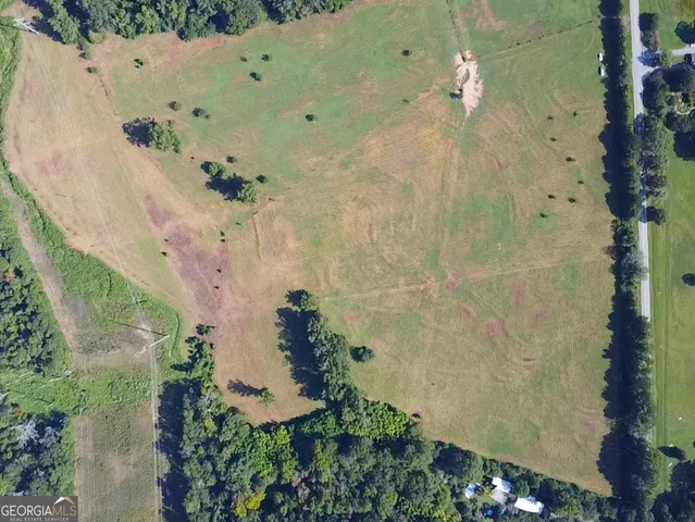 an aerial view of a residential houses with outdoor space
