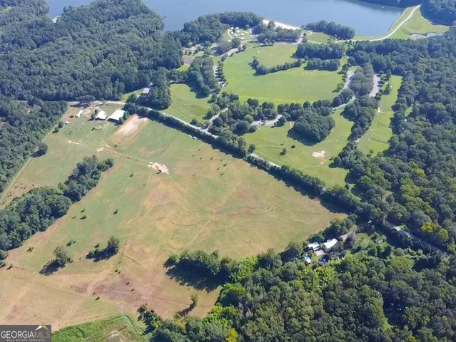 an aerial view of a house with a yard