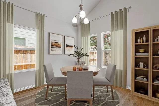 a dining room with furniture and window