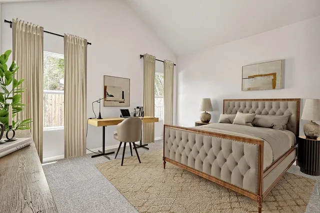 a view of a bedroom with furniture and windows