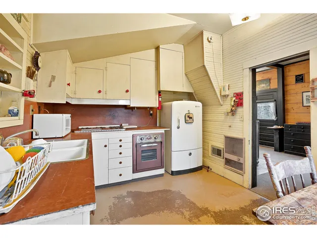 a view of kitchen with furniture and window