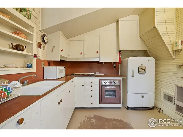 a kitchen with cabinets appliances and a sink