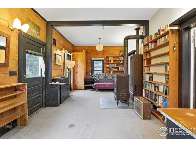 a living room with furniture a flat screen tv and a large window