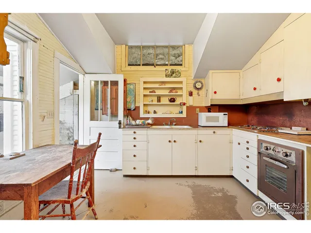 a kitchen with a stove a sink and a cabinets