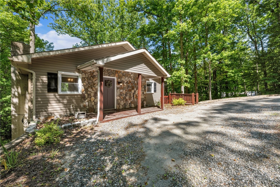 467 Horseshoe Ridge Road East Deep Gap, NC 28618 - Photo 45 of 46 a view of a house with a yard and potted plants