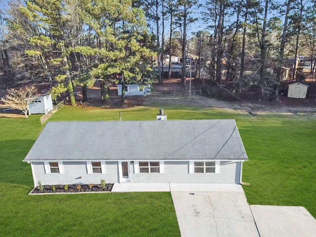 706 Davis Road Lawrenceville, GA 30046 - Photo 1 of 1 an aerial view of a house with swimming pool and yard