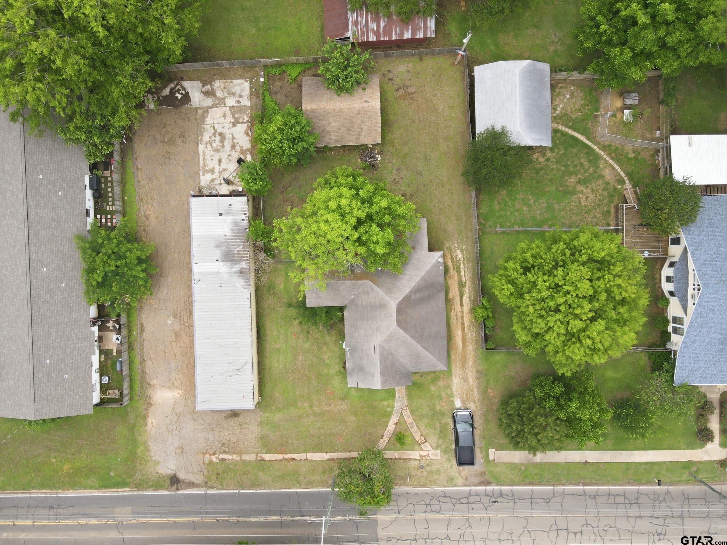 405 Rusk Street Pittsburg, TX 75686 - Photo 31 of 33 a front view of a house with a yard and fountain