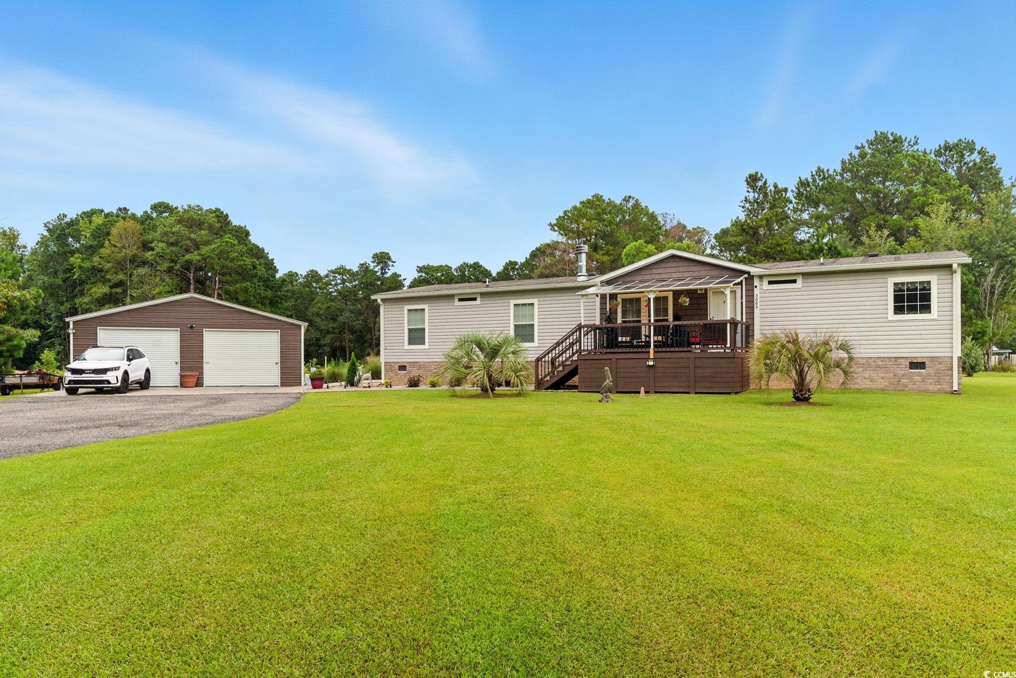 3085 Canady Lane Loris, SC 29569 - Photo 1 of 37 Manufactured / mobile home with crawl space, a garage, a deck, and a front lawn