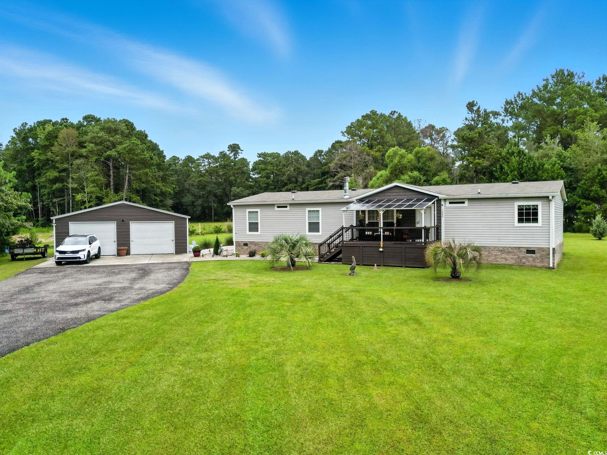 3085 Canady Lane Loris, SC 29569 - Photo 8 of 37 Manufactured / mobile home with crawl space, a detached garage, a wooden deck, an outdoor structure, and a front yard