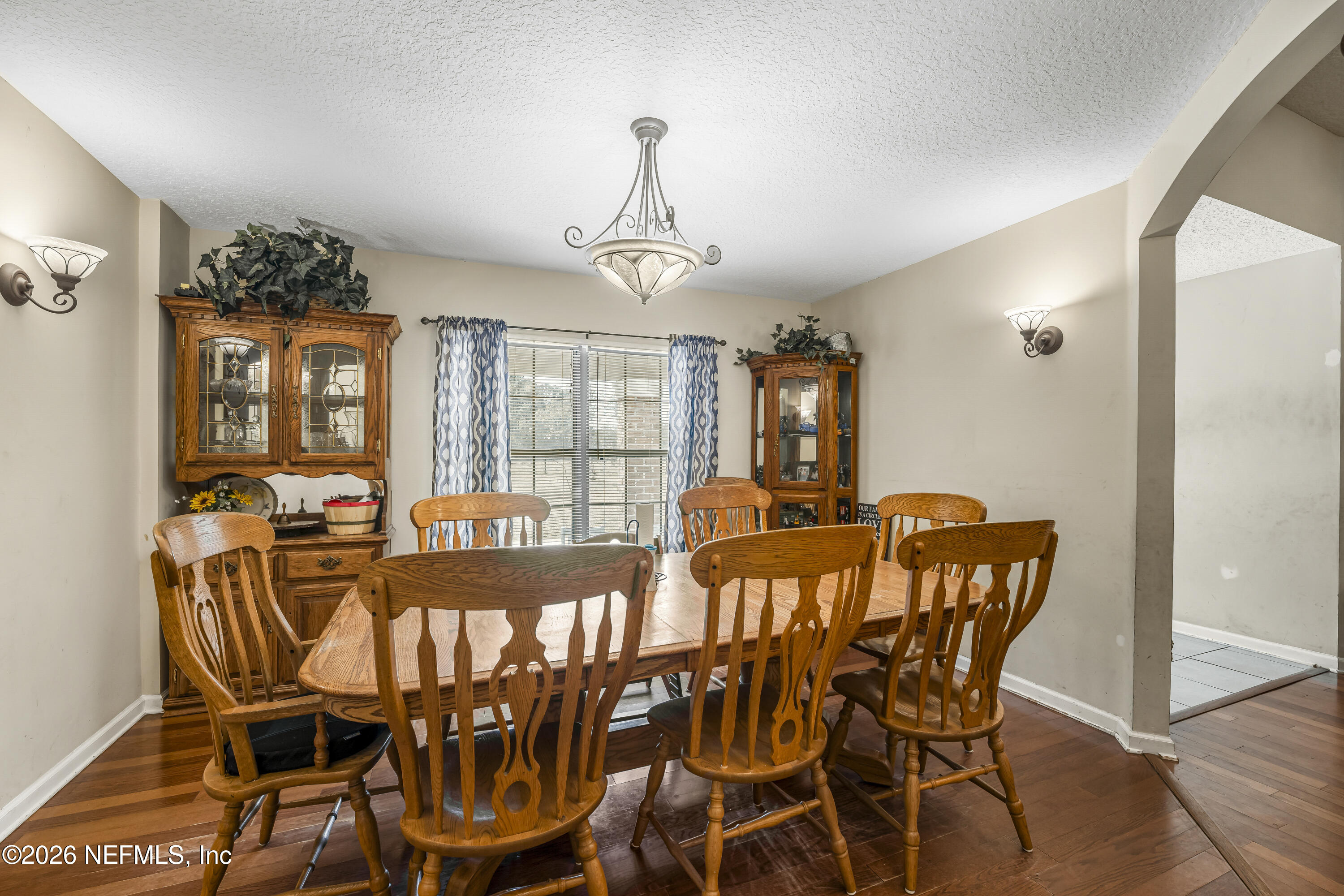 1725 Davidson Farm Road Jacksonville, FL 32218 - Photo 22 of 53 a view of a dining room with furniture wooden floor and chandelier