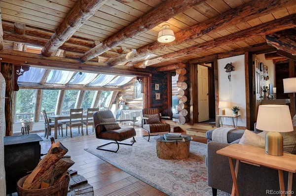 a living room with furniture a fireplace and a large window