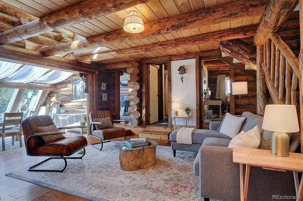 a living room with furniture fireplace and a large window
