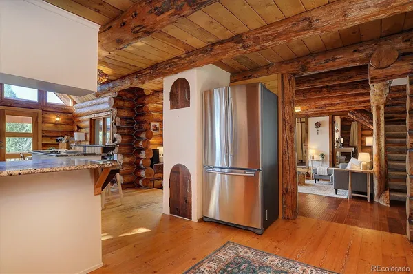 a view of kitchen with furniture and a refrigerator