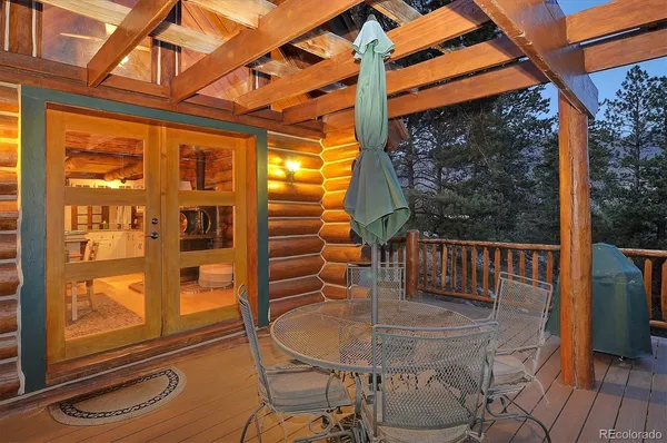 a balcony with table and chairs