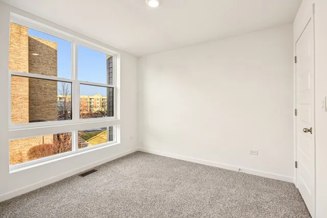 a bathroom with a bathtub shower sink vanity mirror and toilet