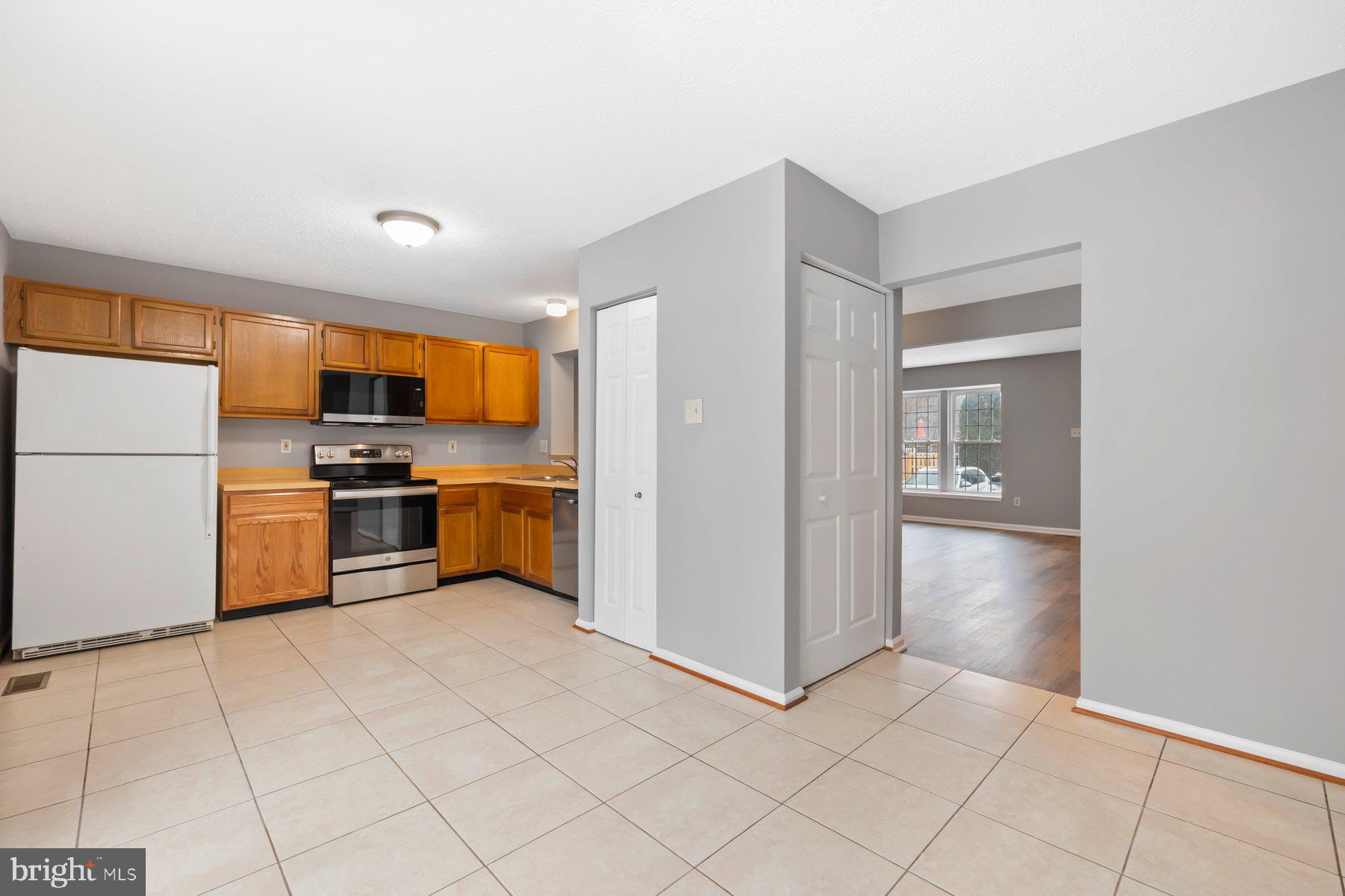6795 Snow Goose Court Frederick, MD 21703 - Photo 11 of 36 a kitchen with stainless steel appliances a refrigerator sink and cabinets