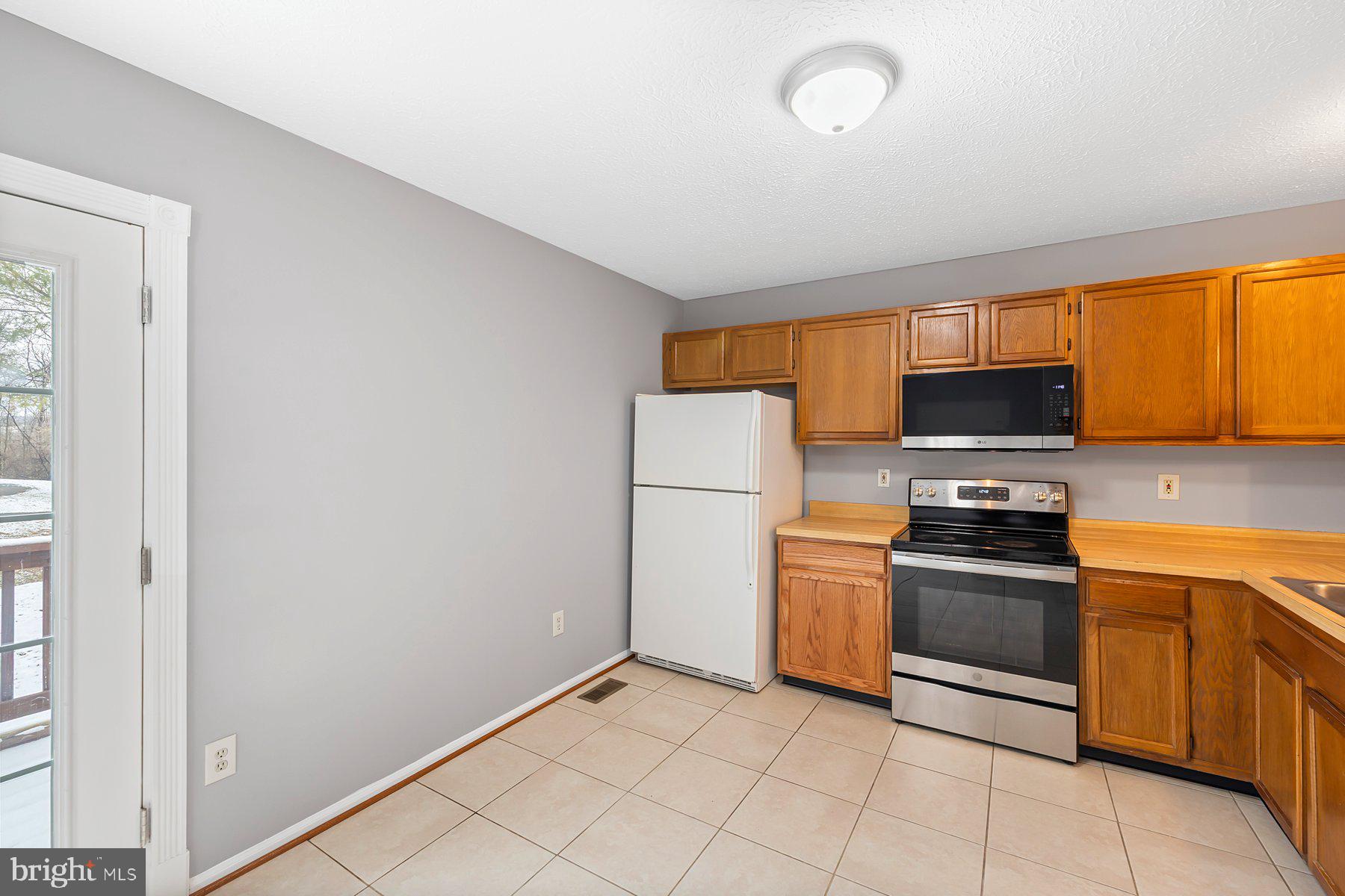 6795 Snow Goose Court Frederick, MD 21703 - Photo 13 of 36 a kitchen with a stove top oven and sink