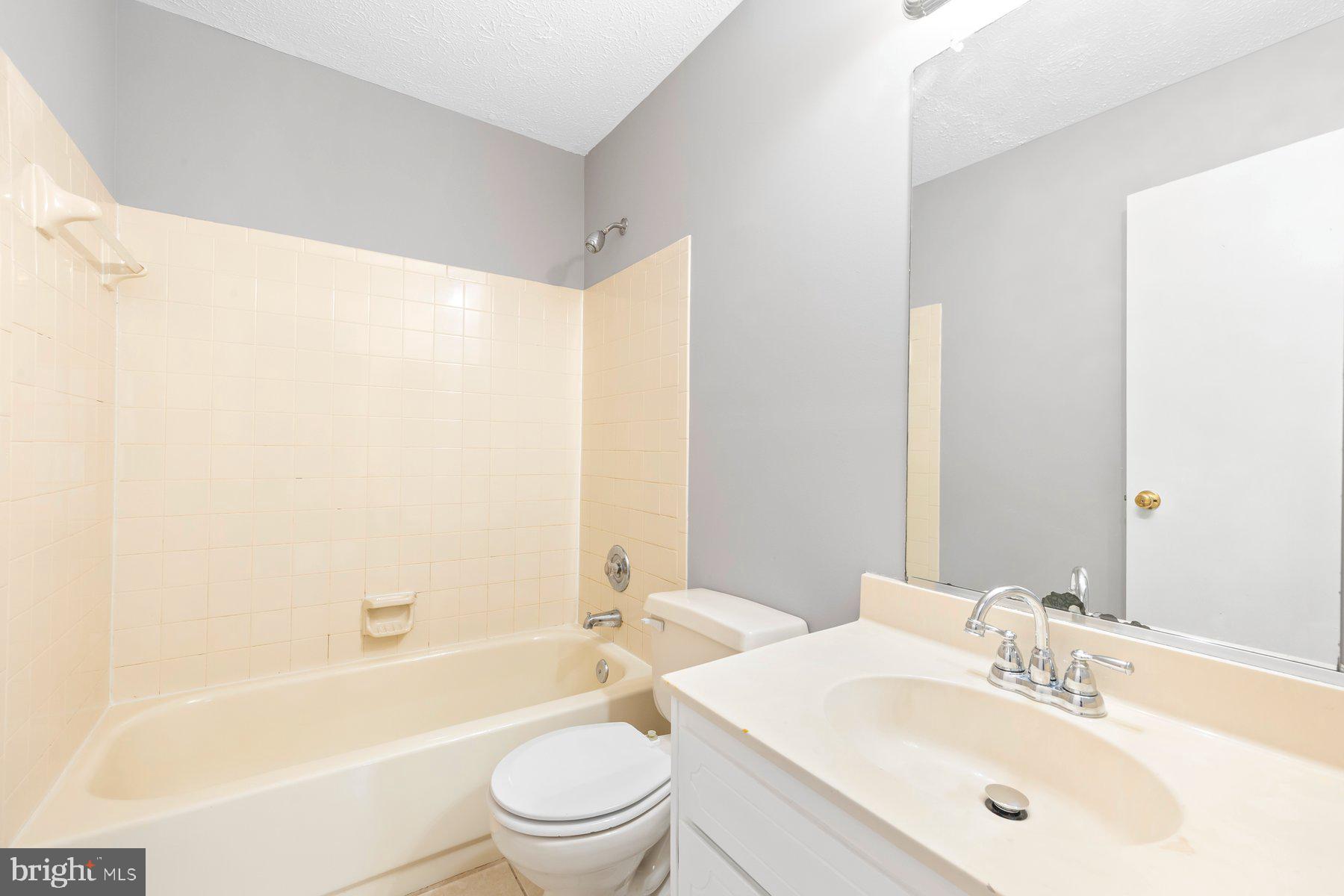 6795 Snow Goose Court Frederick, MD 21703 - Photo 26 of 36 a bathroom with a bathtub shower sink mirror vanity and a toilet