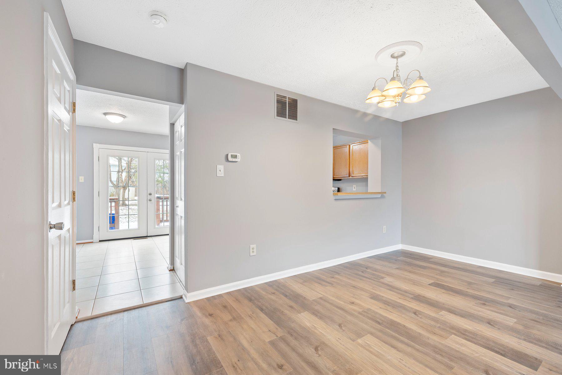 6795 Snow Goose Court Frederick, MD 21703 - Photo 5 of 36 wooden floor in an empty room with a window