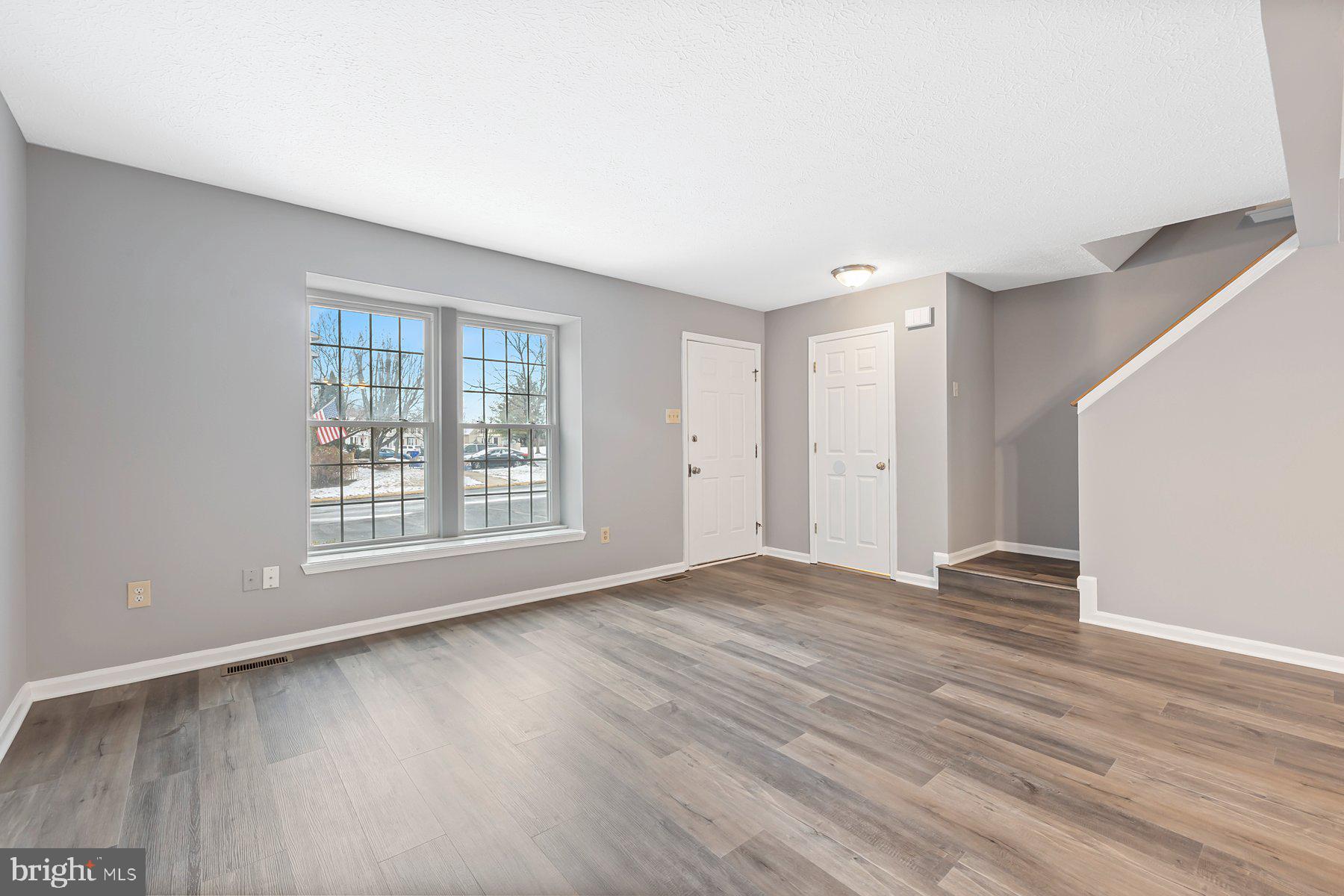 6795 Snow Goose Court Frederick, MD 21703 - Photo 6 of 36 a view of an empty room with wooden floor and a window