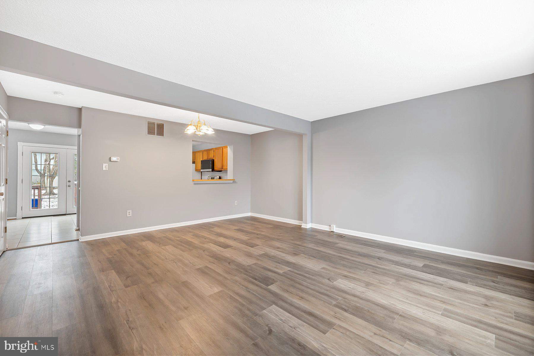 6795 Snow Goose Court Frederick, MD 21703 - Photo 8 of 36 a view of empty room with wooden floor