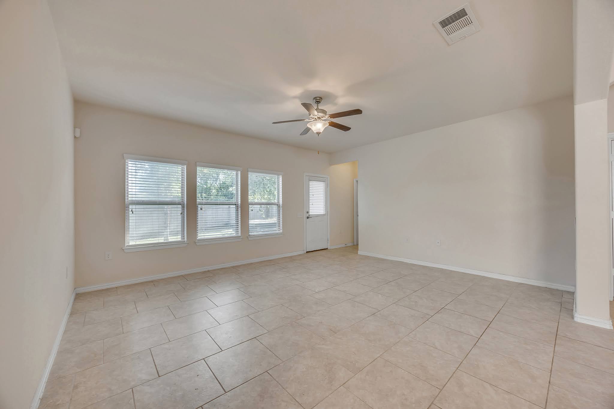 7212 Vail Ridge Street Austin, TX 78744 - Photo 25 of 26 Naturally illuminated living space with durable tiled flooring, perfect for versatile design possibilities.