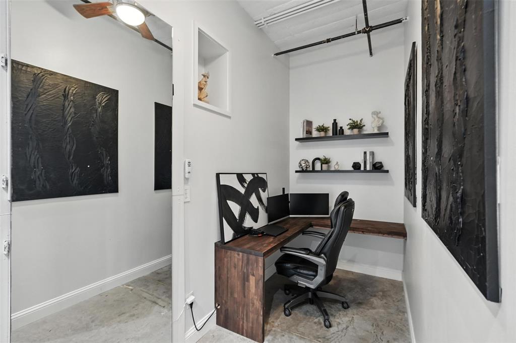 1122 Jackson Street, Unit 719 Dallas, TX 75202 - Photo 12 of 24 a view of a workspace with furniture and a window