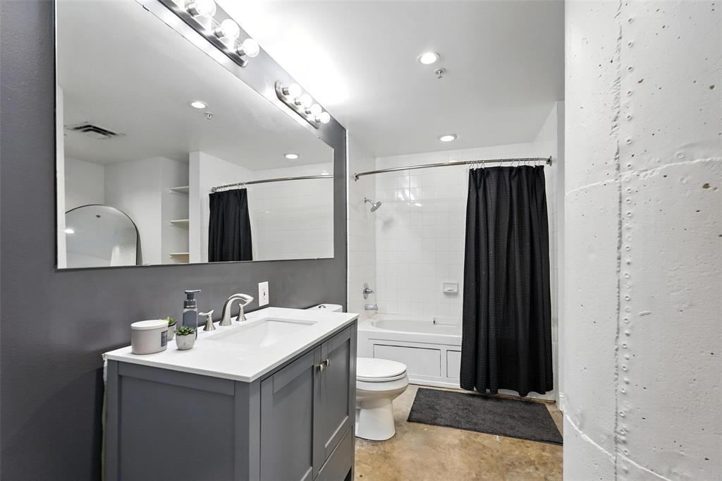 1122 Jackson Street, Unit 719 Dallas, TX 75202 - Photo 9 of 24 a bathroom with a sink toilet and shower