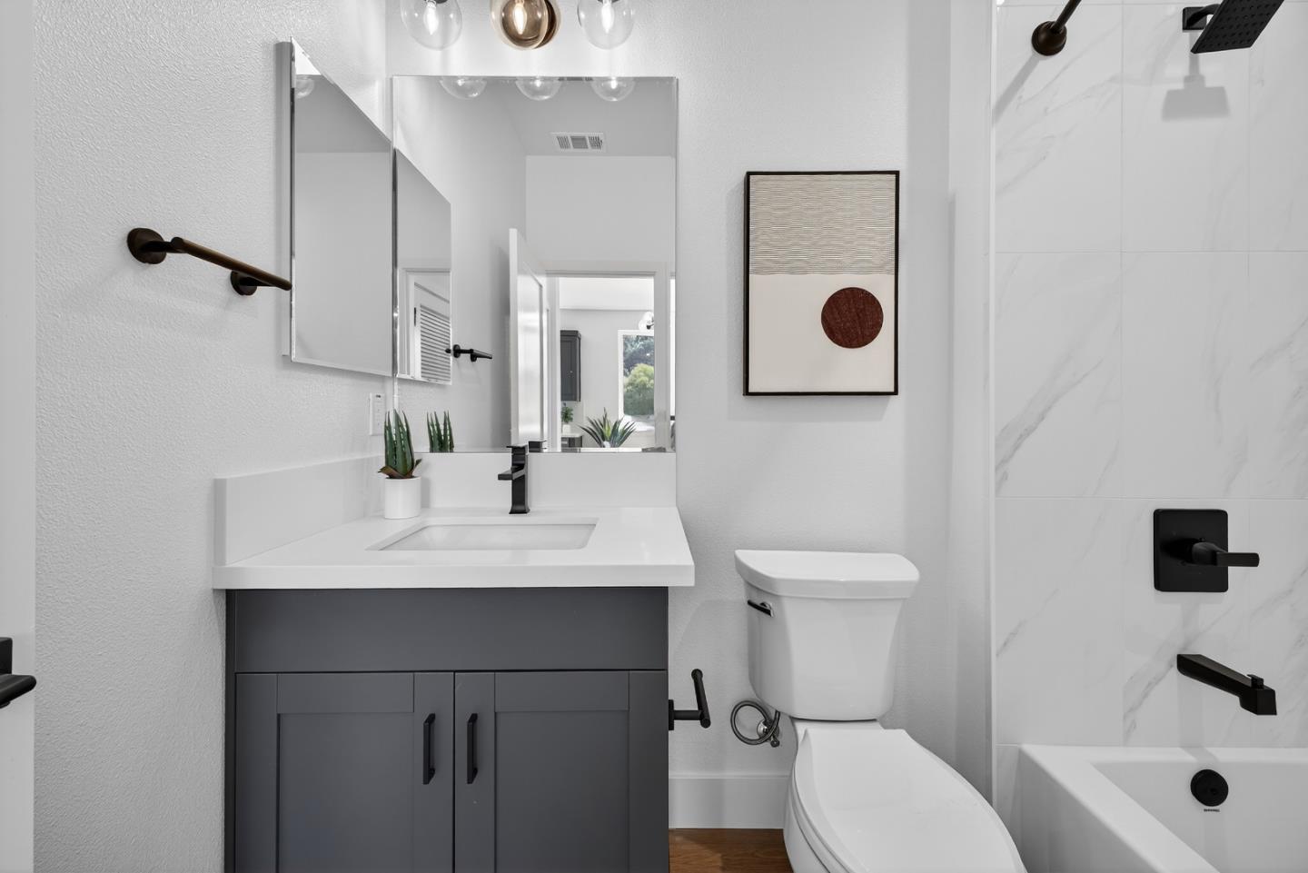 955 Woodside Road Redwood City, CA 94061 - Photo 28 of 46 a bathroom with a sink a toilet and shower