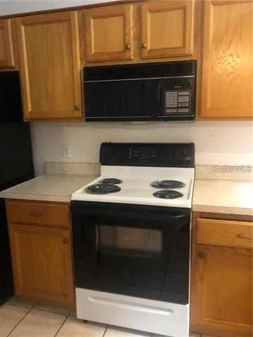a stove top oven sitting inside of a kitchen