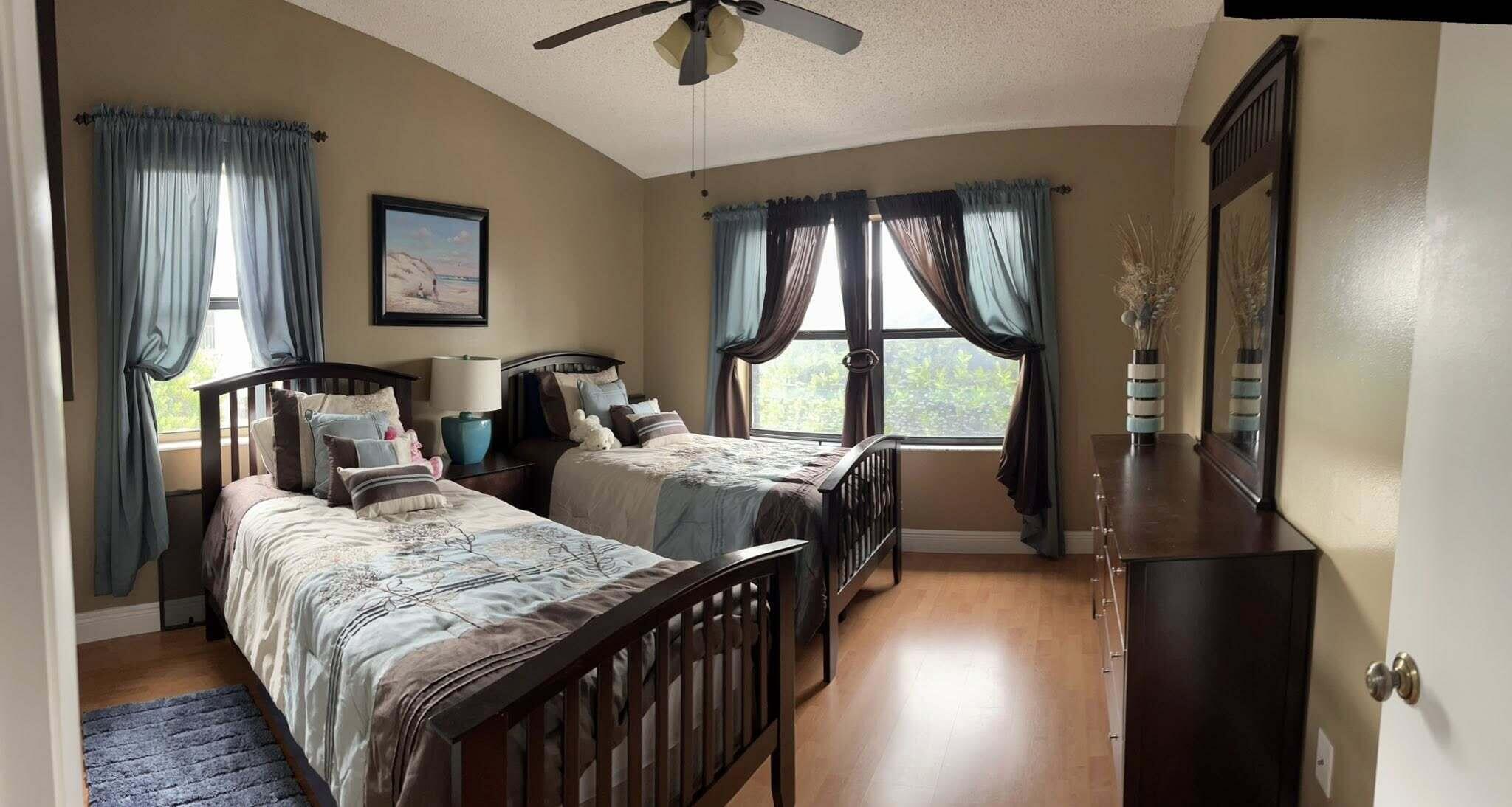 7855 Willow Spring Drive, Unit 726 Lake Worth, FL 33467 - Photo 11 of 16 a bedroom with two beds and a window