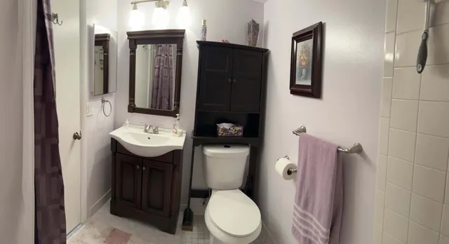 a bathroom with a sink toilet and shower