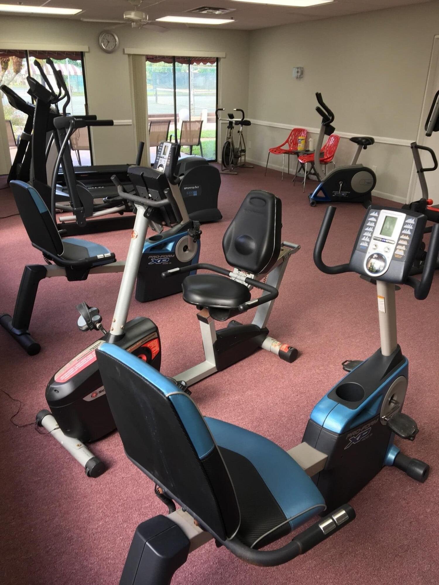 7855 Willow Spring Drive, Unit 726 Lake Worth, FL 33467 - Photo 15 of 16 a room with gym equipment and windows