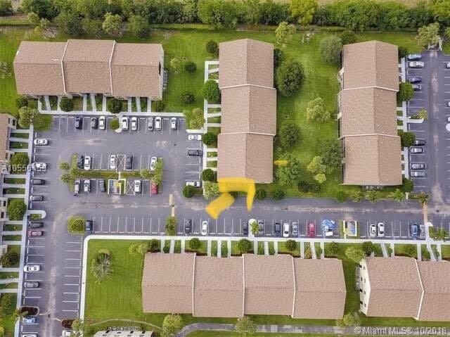 7855 Willow Spring Drive, Unit 726 Lake Worth, FL 33467 - Photo 16 of 16 an aerial view of a house with a garden and lake view