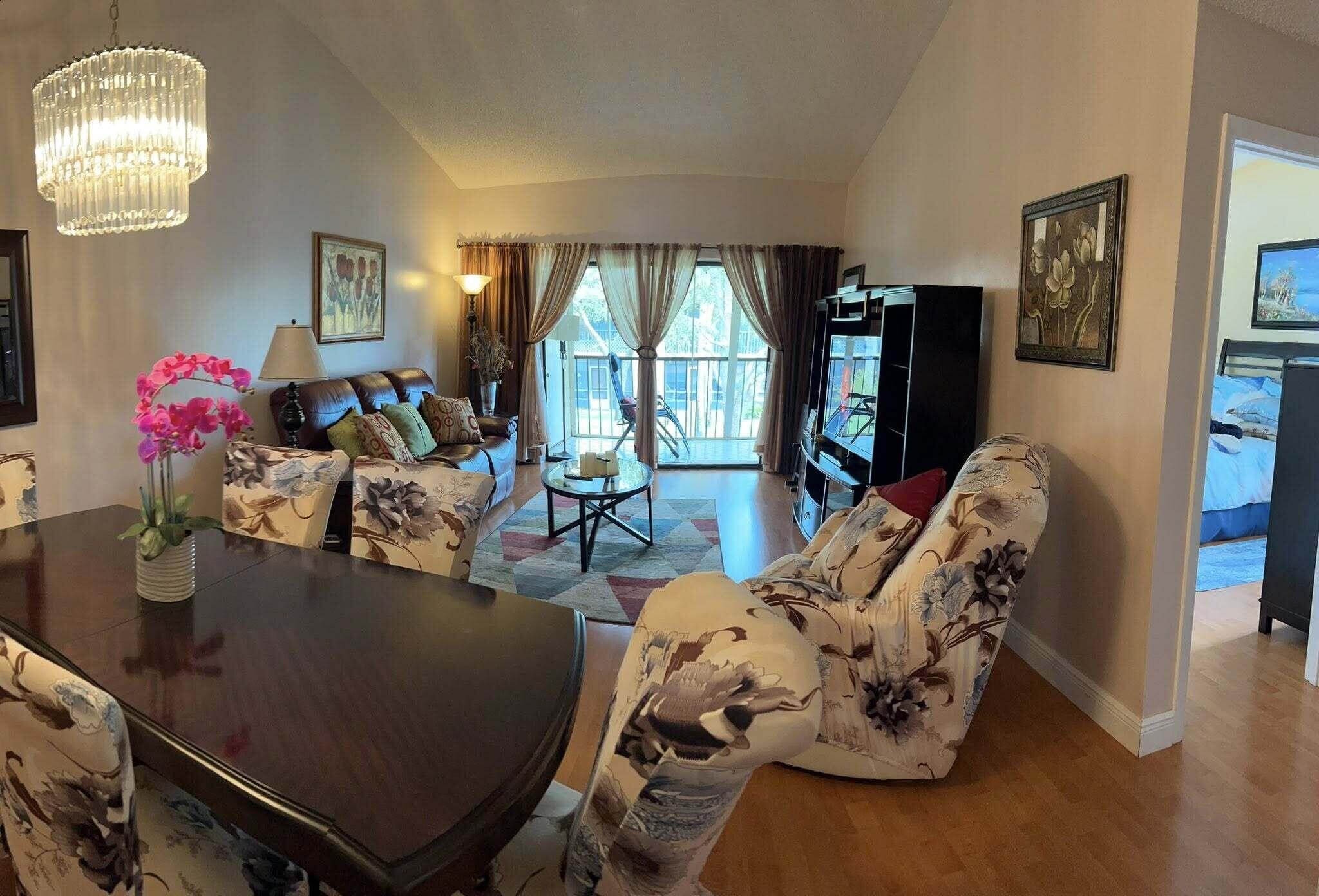 7855 Willow Spring Drive, Unit 726 Lake Worth, FL 33467 - Photo 5 of 16 a view of a livingroom with furniture window and wooden floor
