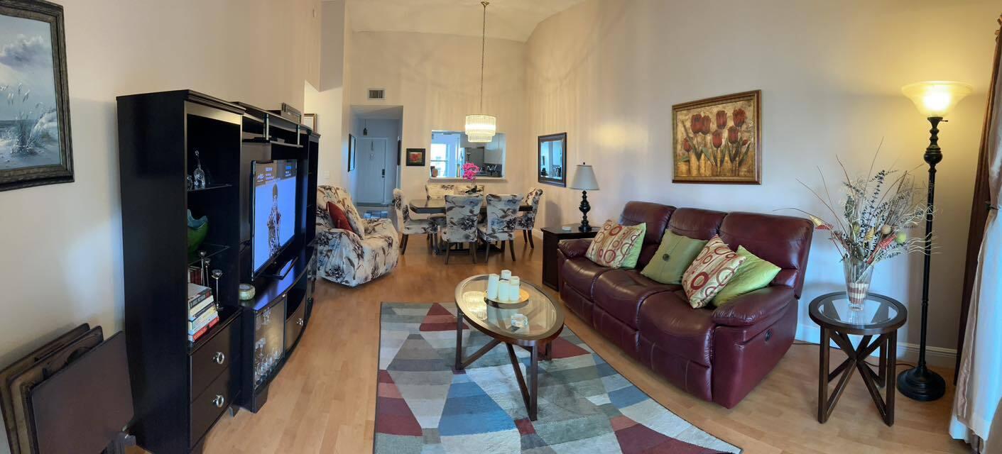 7855 Willow Spring Drive, Unit 726 Lake Worth, FL 33467 - Photo 7 of 16 a living room with fireplace furniture and a flat screen tv