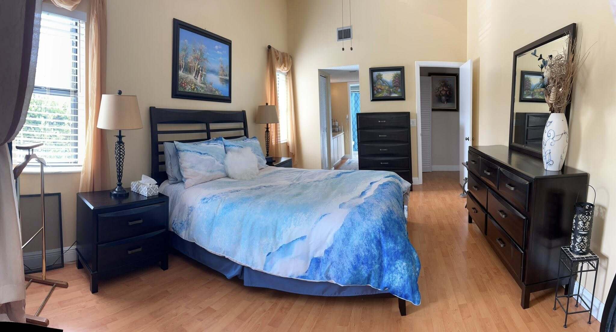 7855 Willow Spring Drive, Unit 726 Lake Worth, FL 33467 - Photo 8 of 16 a bedroom with a bed dresser and mirror