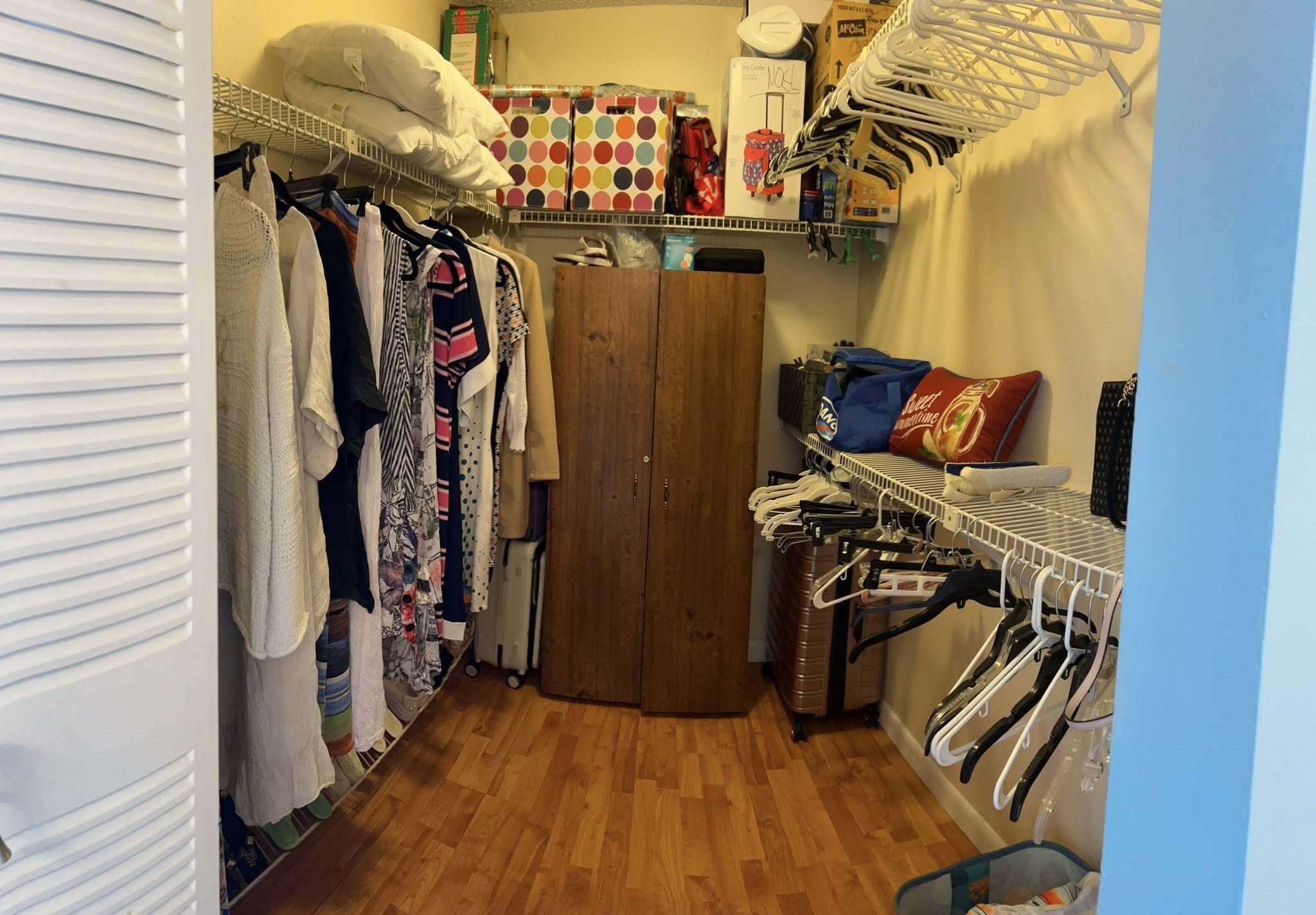 7855 Willow Spring Drive, Unit 726 Lake Worth, FL 33467 - Photo 9 of 16 a view of walk in closet with clothes and shoes