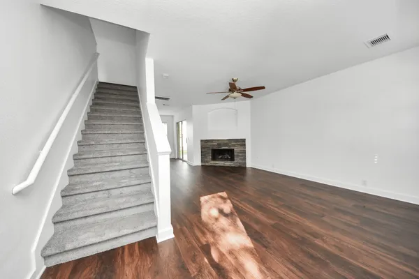a view of entryway and hall with wooden floor
