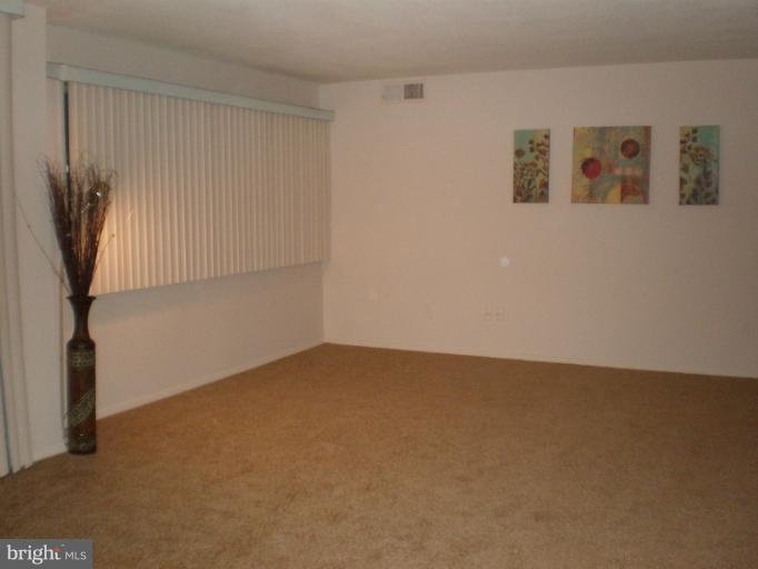 1836 Metzerott Road, Unit 1711 Hyattsville, MD 20783 - Photo 10 of 16 a view of an empty room with window and stairs