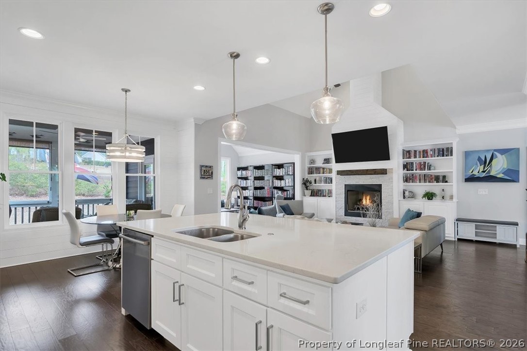10 Heatherspring Way Spring Lake, NC 28390 - Photo 22 of 48 a kitchen with a stove a oven a dining table and chairs with wooden floor