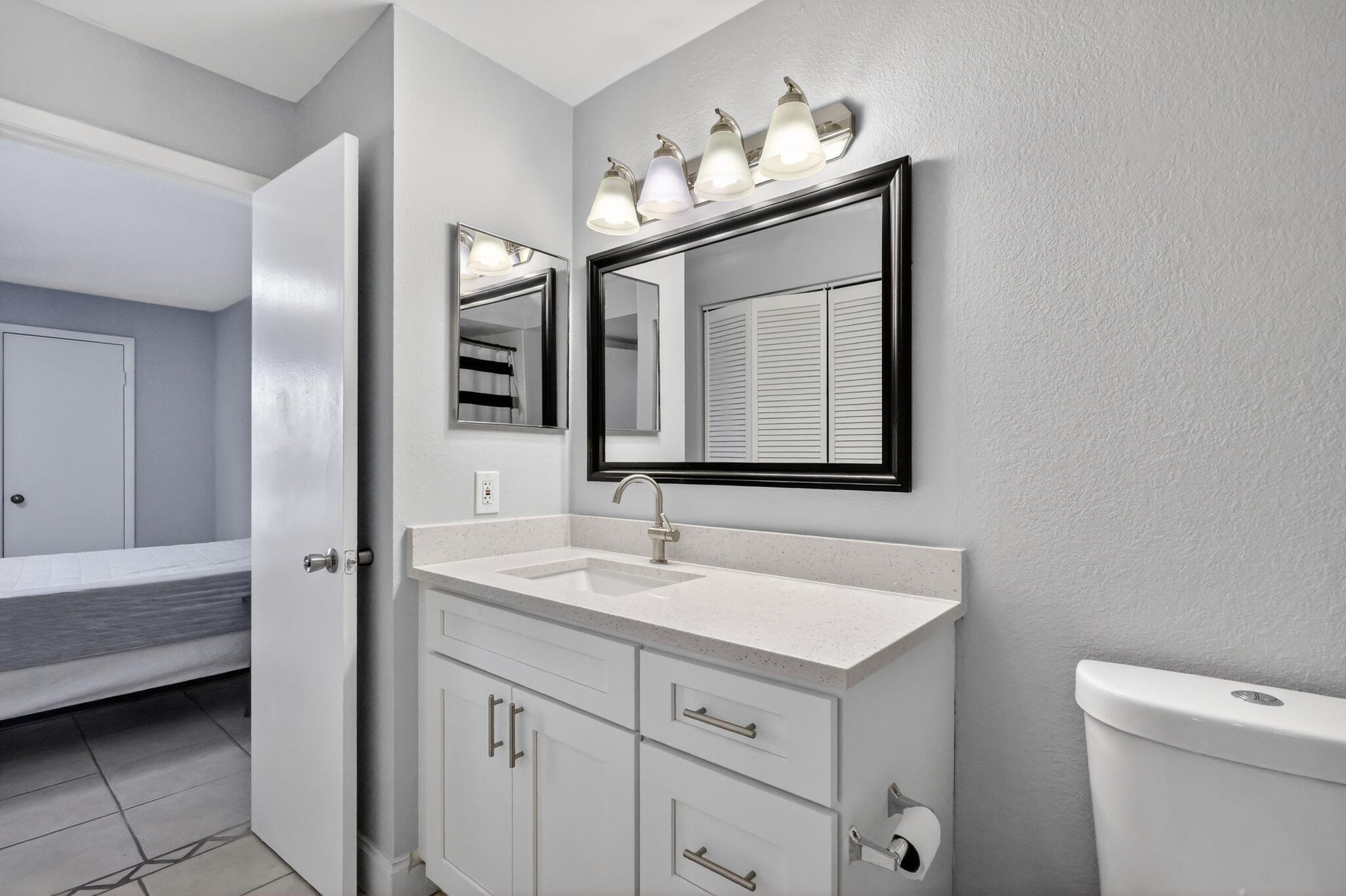 1740 Palm Cove Boulevard, Unit 4307 Delray Beach, FL 33445 - Photo 12 of 31 a bathroom with a toilet sink and mirror