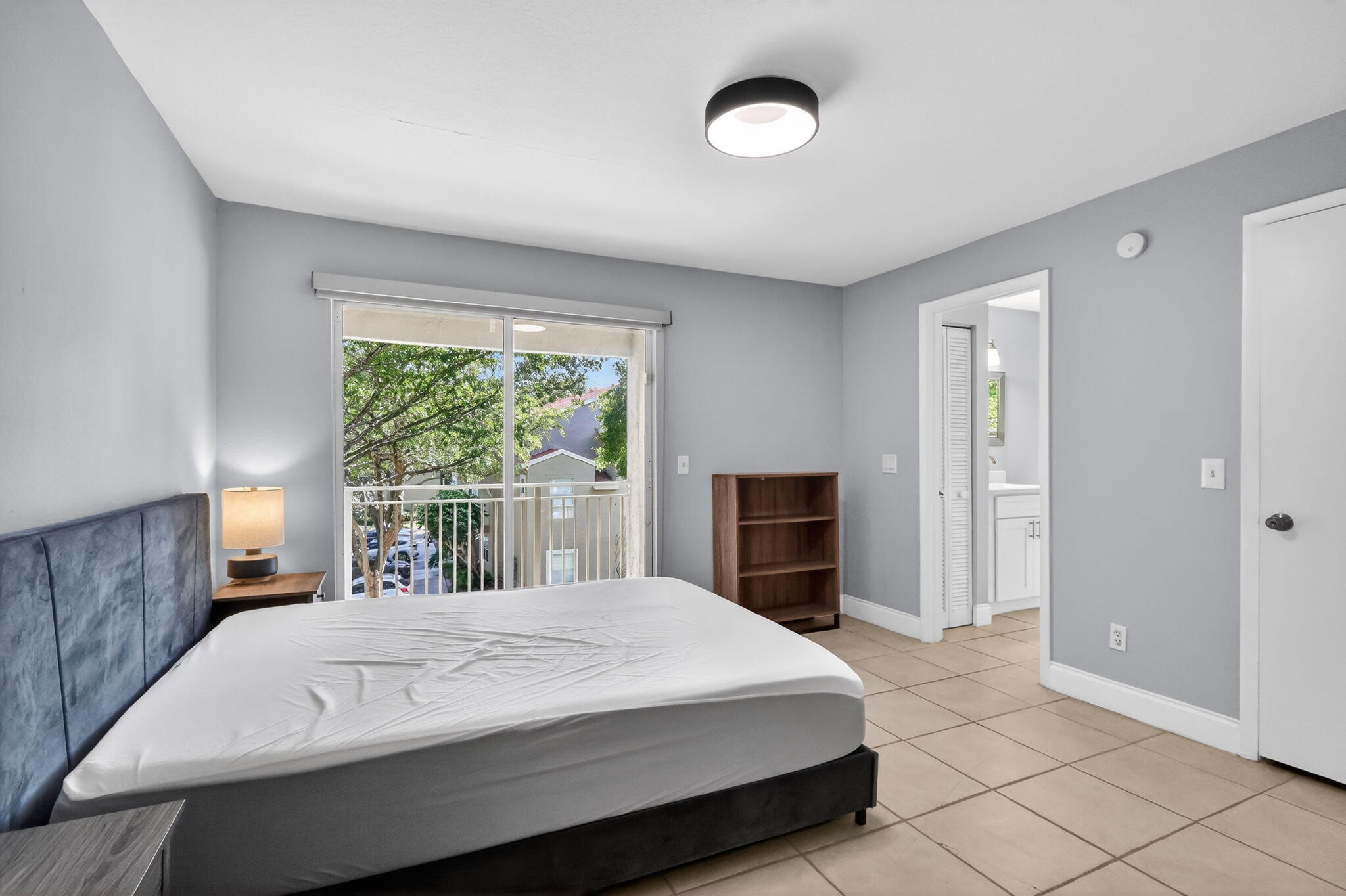 1740 Palm Cove Boulevard, Unit 4307 Delray Beach, FL 33445 - Photo 13 of 31 a spacious bedroom with a large bed and a fireplace