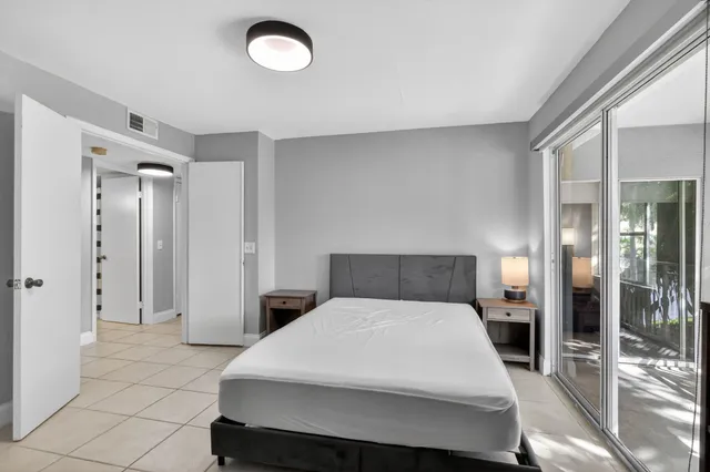 a bathroom with a granite countertop sink toilet and mirror