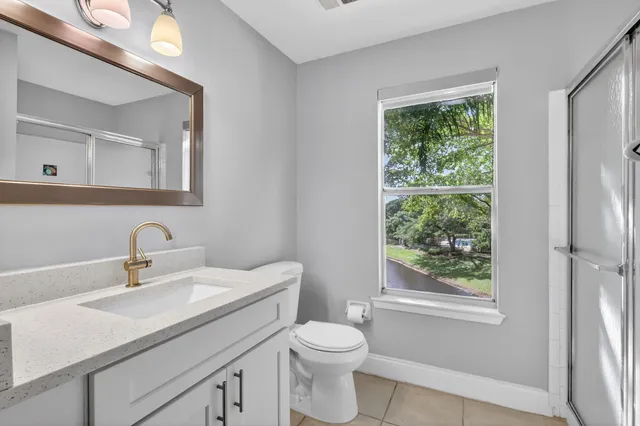 a bathroom with a glass shower door