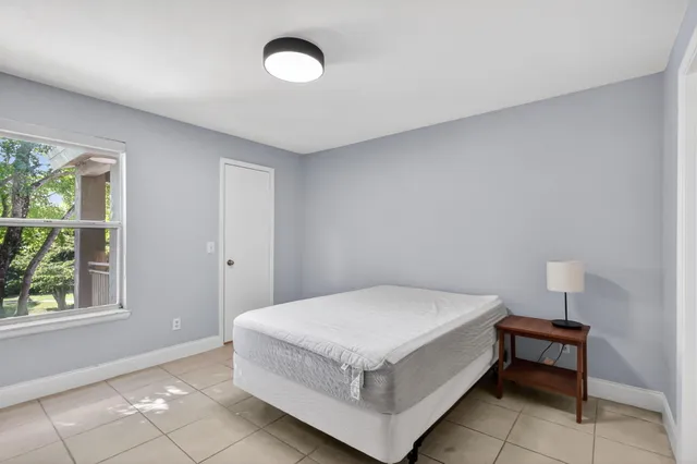 a room with a bed and a lamp