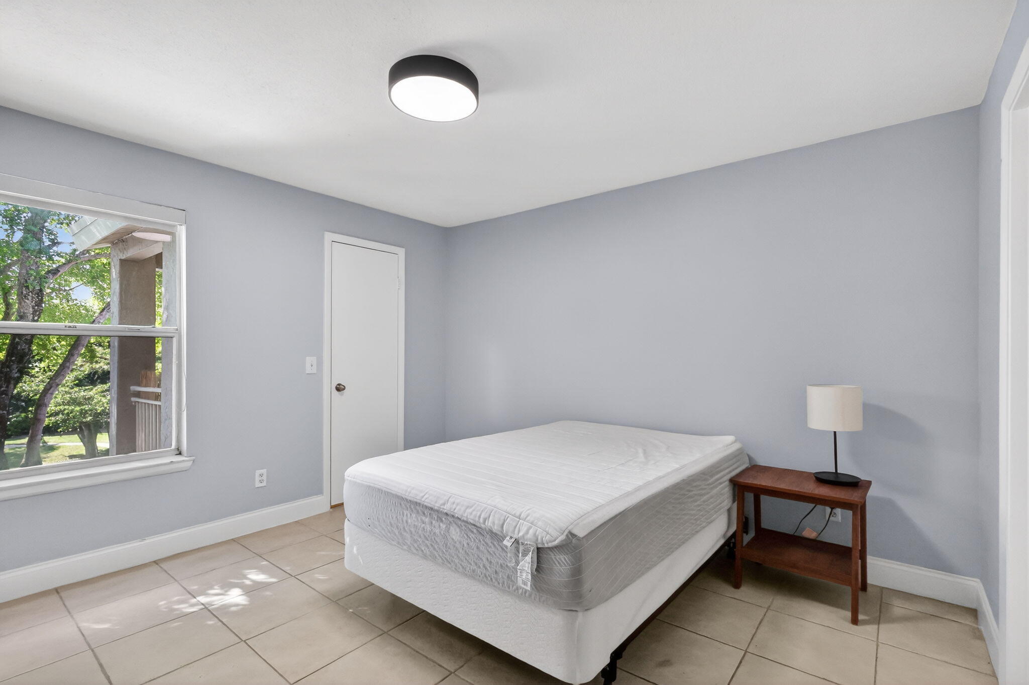 1740 Palm Cove Boulevard, Unit 4307 Delray Beach, FL 33445 - Photo 18 of 31 a white bed sitting in a room next to a window