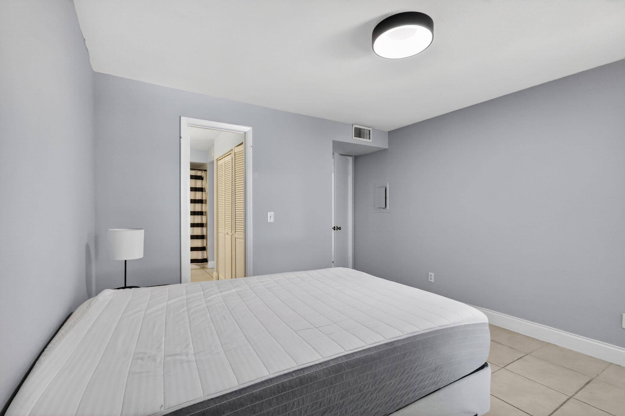 1740 Palm Cove Boulevard, Unit 4307 Delray Beach, FL 33445 - Photo 20 of 31 a bedroom with a bed and a window