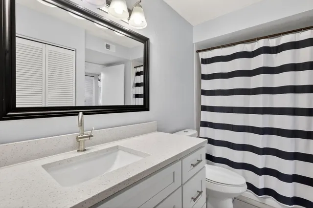 a view of a bathroom with a black and white checkered floor